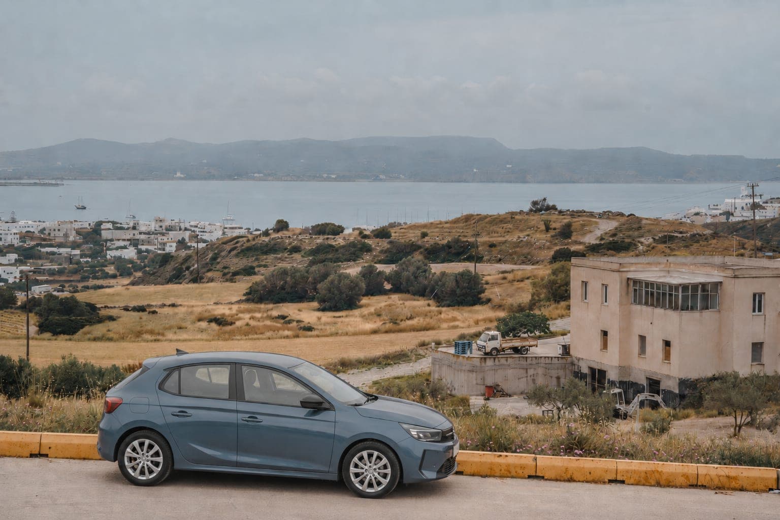 Rental car on a road in Milos, Greece.