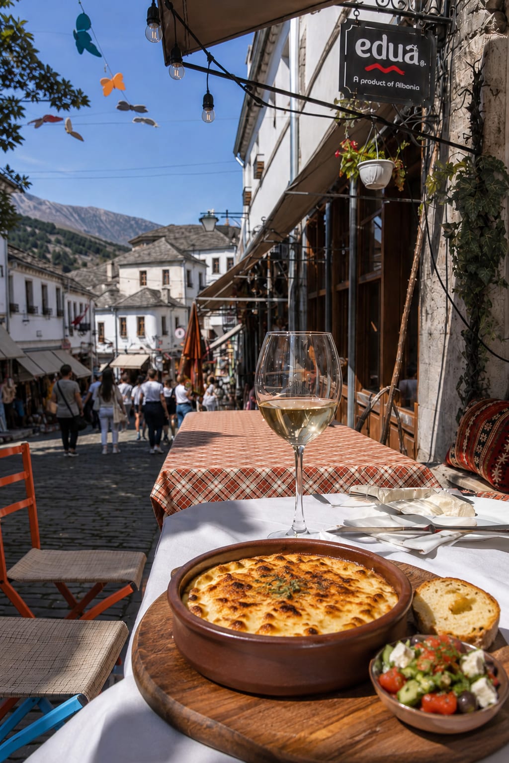 Outdoor dining area along a historic street in Gjirokaster