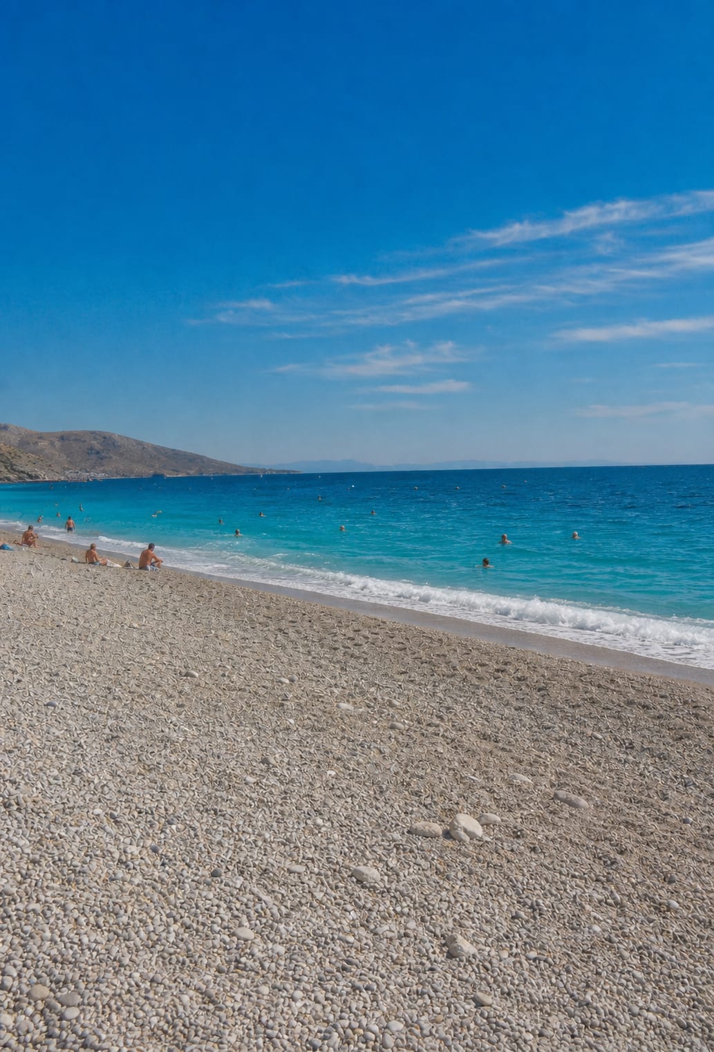 Sandy shoreline and sunlit beach scene at Dhermi Beach