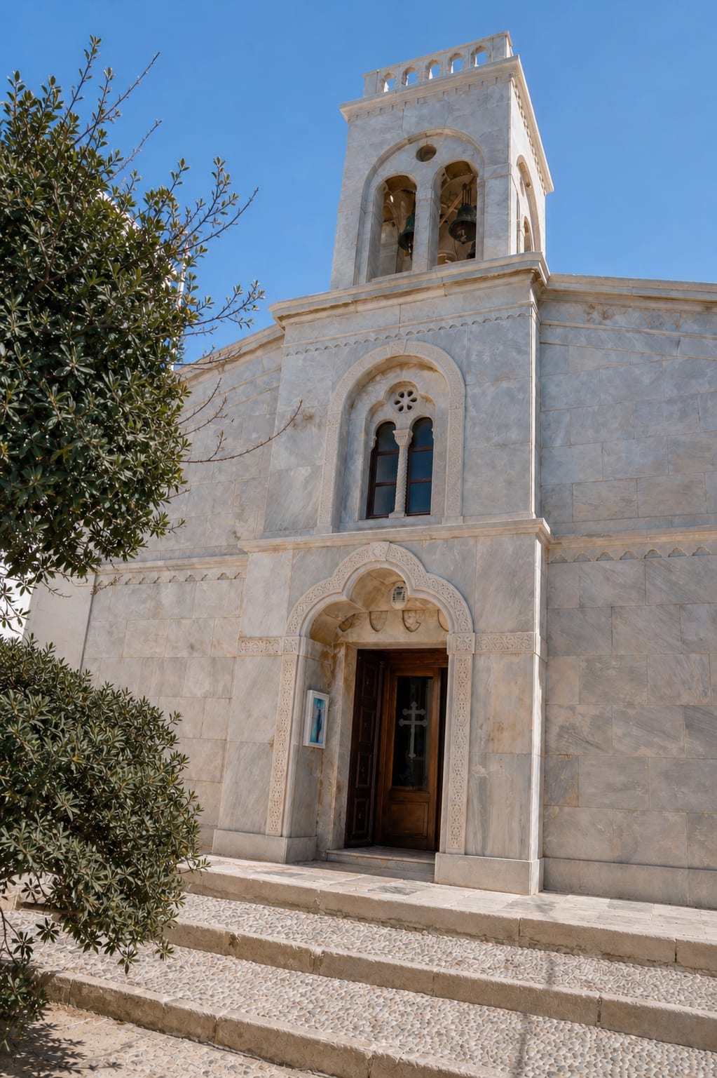 Historic church in Naxos Old Town among traditional Cycladic buildings.