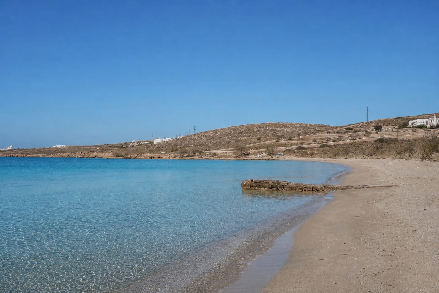 Marcello Beach in Paros with golden sand and clear blue water.