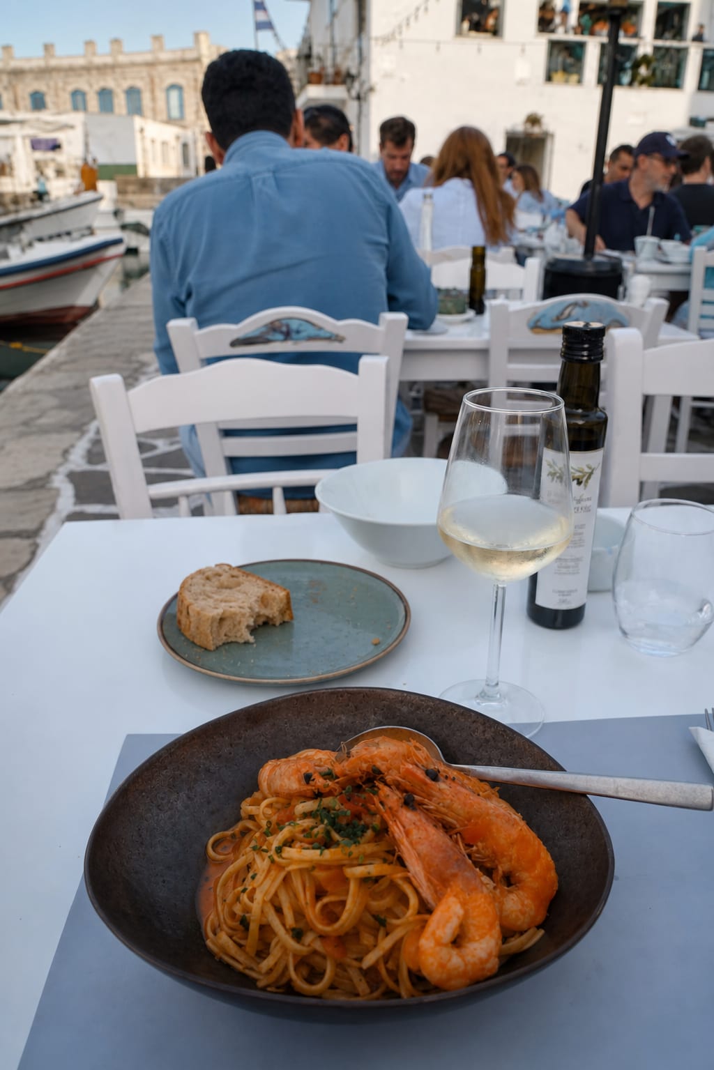 Naoussa Marina in Paros with waterfront dining and evening harbor views.