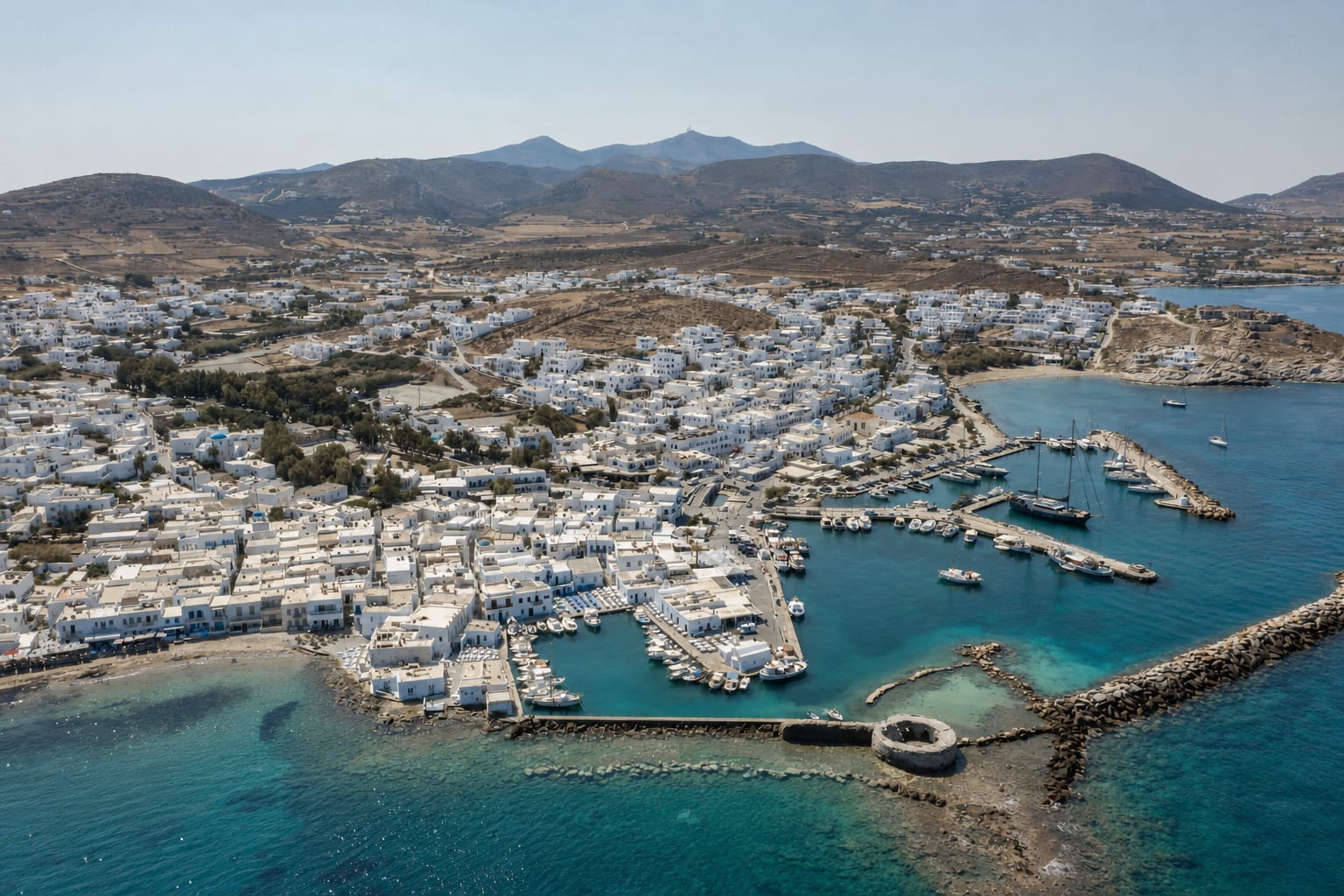 Naoussa village in Paros with traditional Cycladic streets and harbor views.